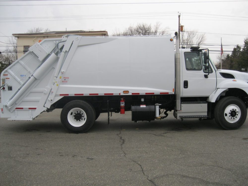 Side view of white New Way Trash Truck