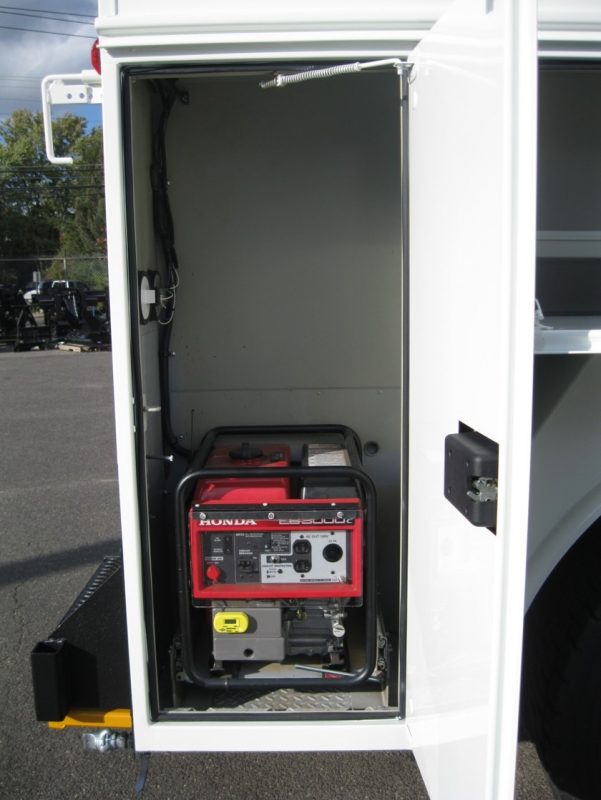 Opened compartment on truck showing generator
