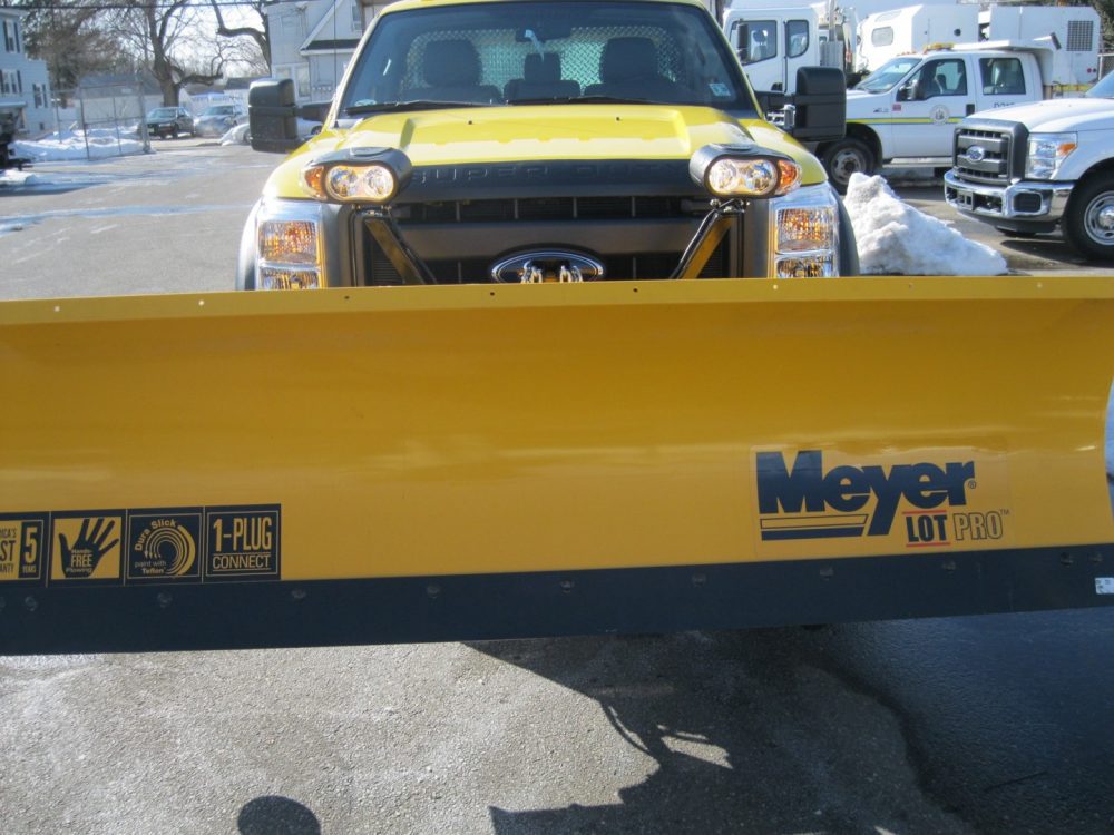 Front view of snow plow on yellow truck