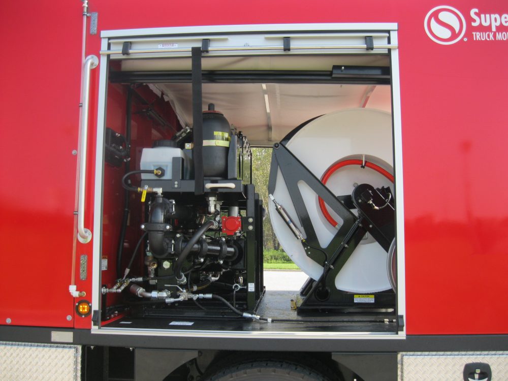 Opened side door of red truck showing equipment
