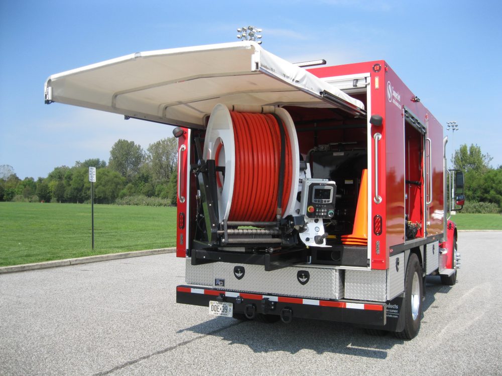 View of trunk of red truck with wire equipment