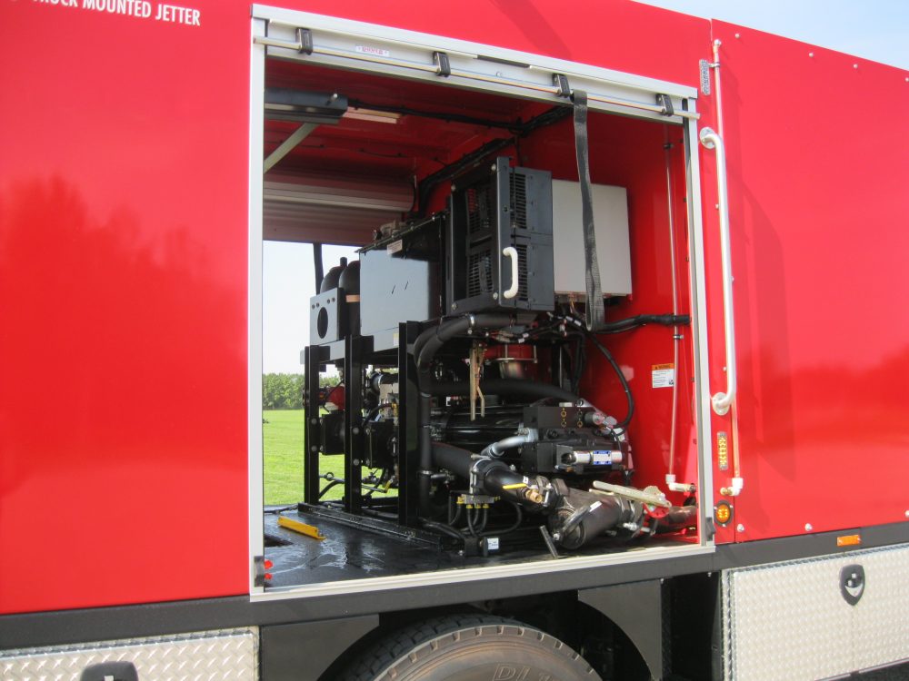 Side door to red truck with equipment inside