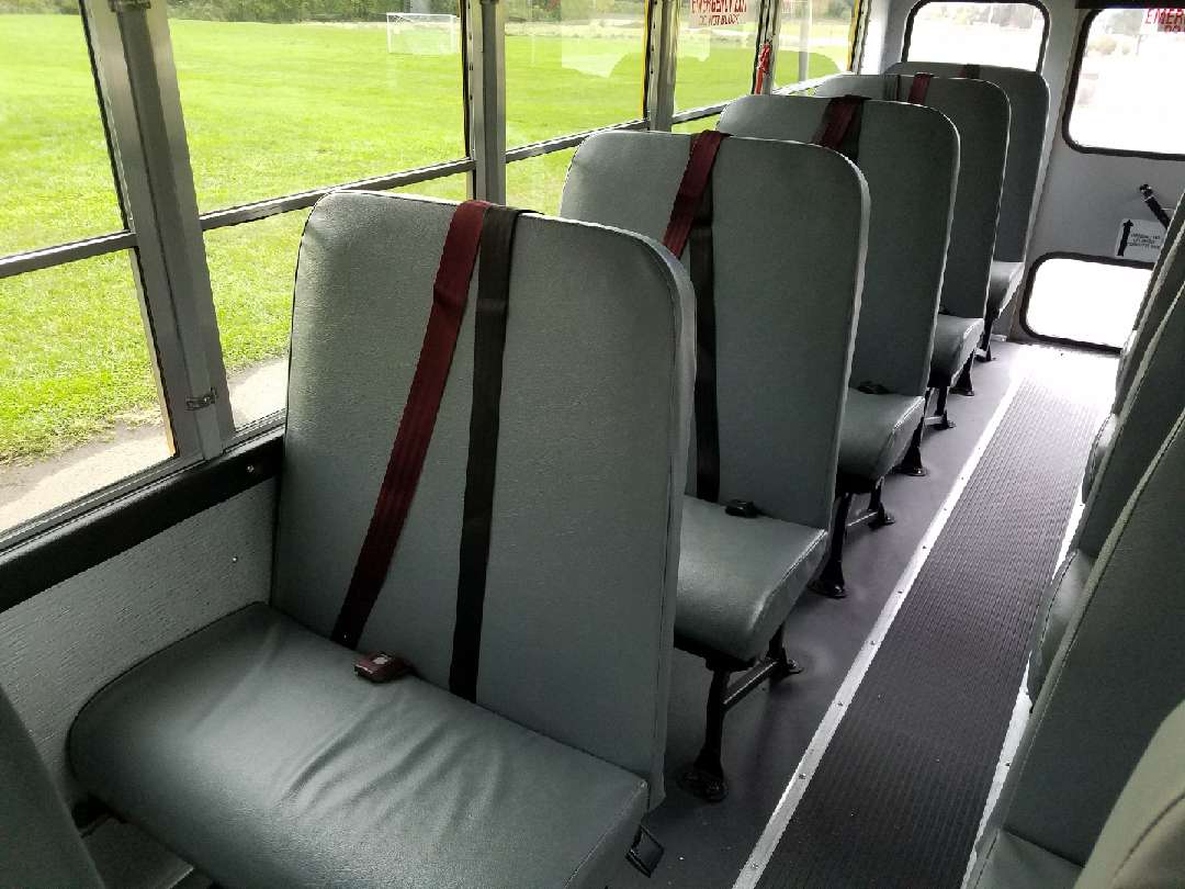 Passenger side leather seats inside schoolbus