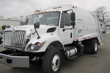 Front right view of white garbage truck