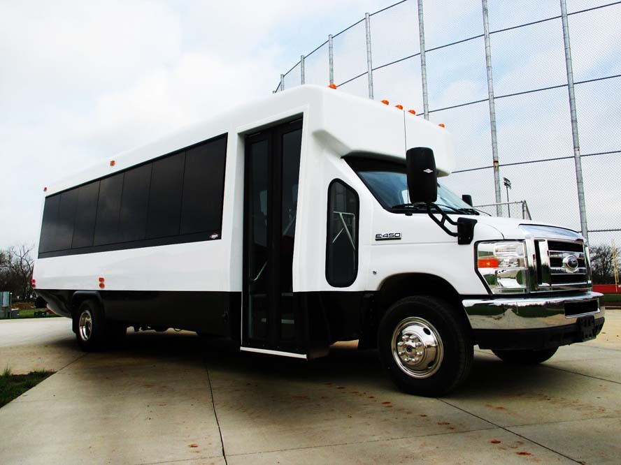 Front right side view of white bus with black windows