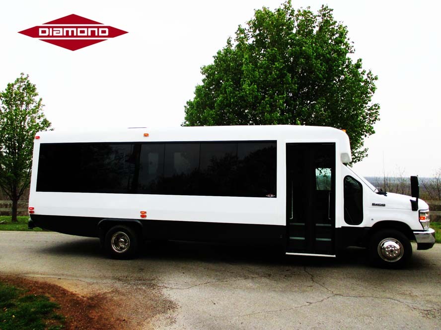Right side view of white bus with black windows