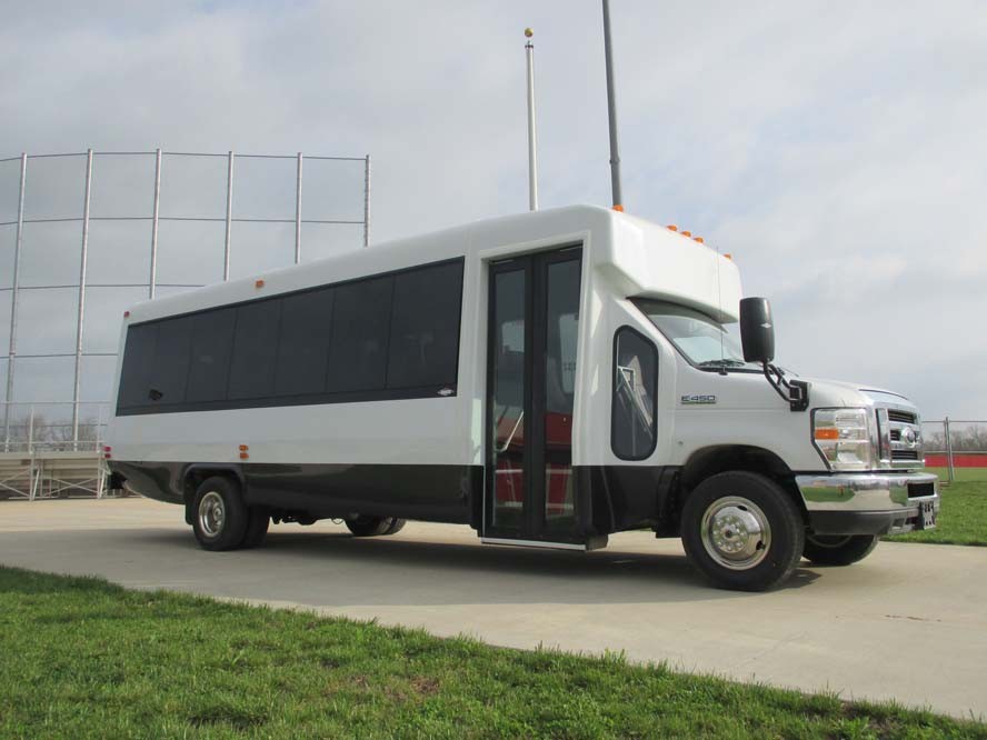 Front right view of white bus with black windows