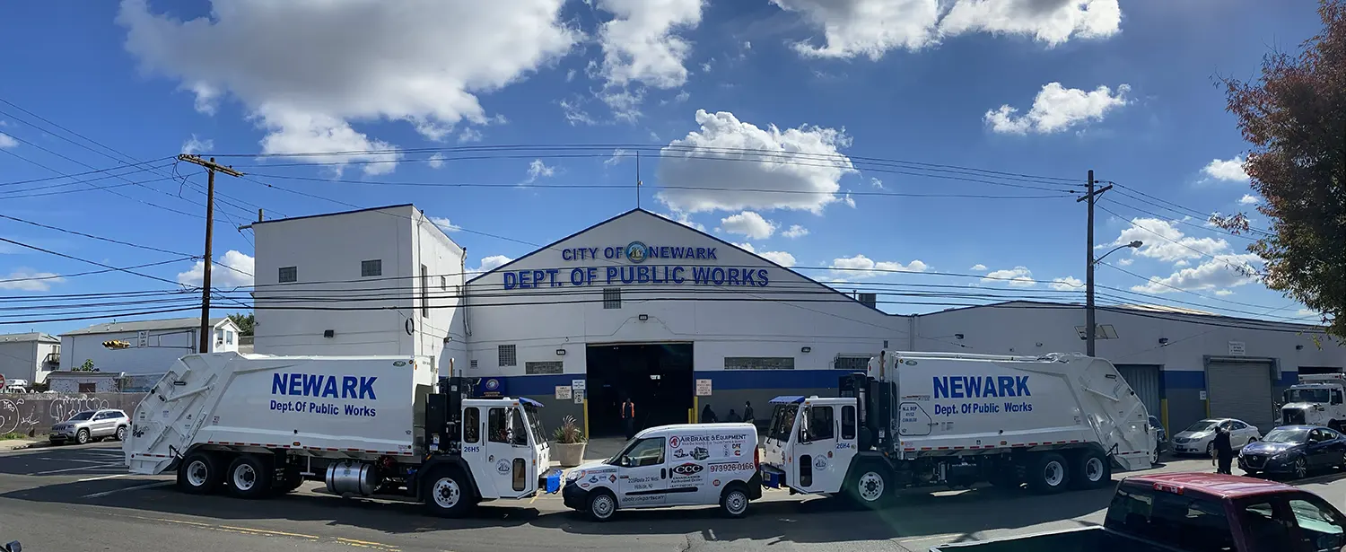 Garbage trucks parked in front of public works building for City of Newark