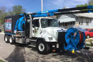 White and blue sewer truck with equipment