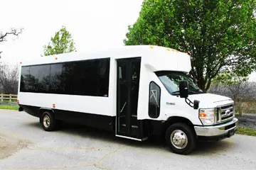 White bus with large black windows all along side
